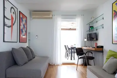 a living room with a couch and a table at Homz AH02 Kolonaki Penthouse Studio in Athens