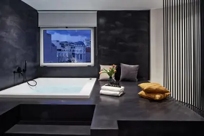 a bathroom with a white tub and a window at Athens4 in Athens