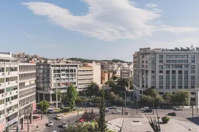 a view of a city with buildings and cars at Acropolis View - Living Stone Sapphire Apartment in Athens