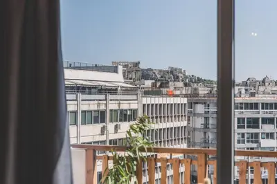 a view of a city from a window at Acropolis View - Living Stone Sapphire Apartment in Athens