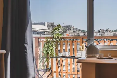 a room with a balcony with a tea kettle on a table at Acropolis View - Living Stone Sapphire Apartment in Athens