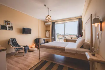 a hotel room with a bed and a window at Acropolis View - Living Stone Sapphire Apartment in Athens