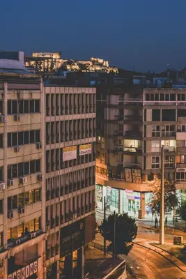 a group of buildings in a city at night at Acropolis View - Living Stone Sapphire Apartment in Athens
