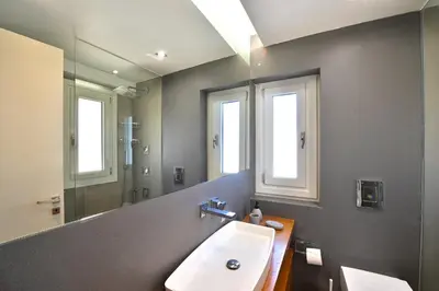 a bathroom with a sink and a mirror at Villa Domus Riviera in Athens