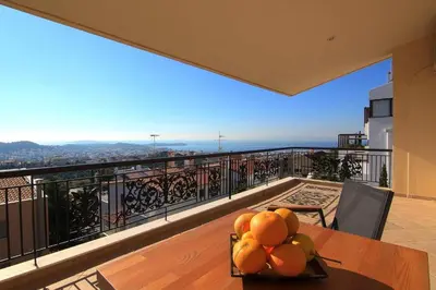 a bowl of oranges on a table on a balcony at Villa Domus Riviera in Athens
