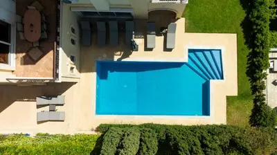 an overhead view of a swimming pool in front of a house at Villa Domus Riviera in Athens