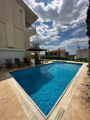 a swimming pool in front of a villa at Villa Domus Riviera in Athens