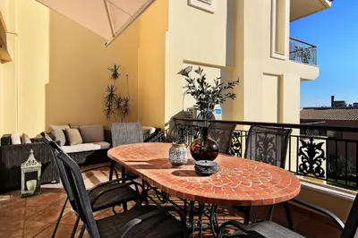 a patio with a table and chairs on a balcony at Villa Domus Riviera in Athens
