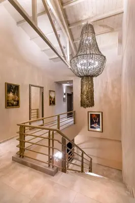 a large chandelier in a room with a staircase at Athens Manor Houses in Athens
