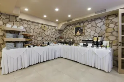 a restaurant with a long table in a room at Athens Manor Houses in Athens