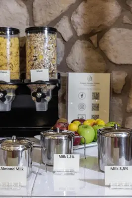 a table with jars of food and fruits on a counter at Athens Manor Houses in Athens