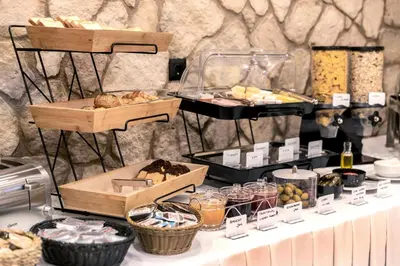 a buffet with bread and pastries on a table at Athens Manor Houses in Athens