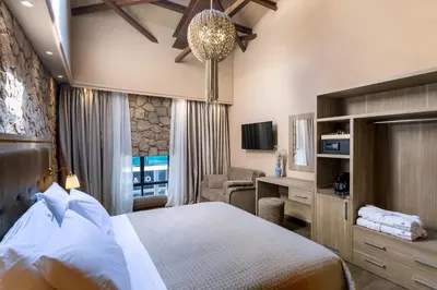 a hotel room with a bed and a desk at Athens Manor Houses in Athens