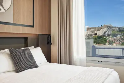 a bedroom with a bed and a window with a view at Urban Frame Plaka in Athens