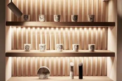 a room with wooden shelves with cups and a mirror at Urban Frame Plaka in Athens