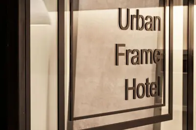 a glass window with a sign that reads united frame hotel at Urban Frame Plaka in Athens