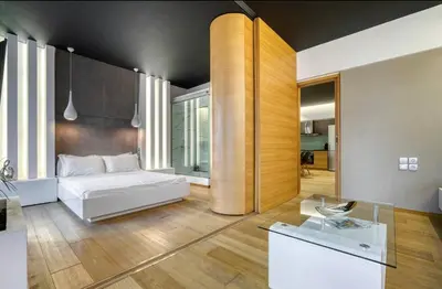 a living room with a white bed and a table at Zolie Apartment in Athens