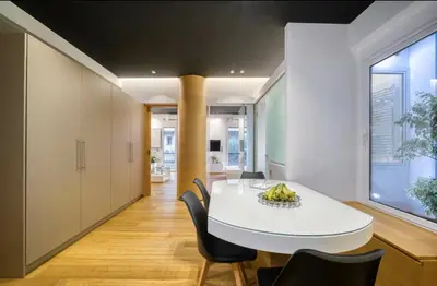 a dining room with a white table and chairs at Zolie Apartment in Athens