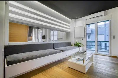 a living room with a couch and a table at Zolie Apartment in Athens