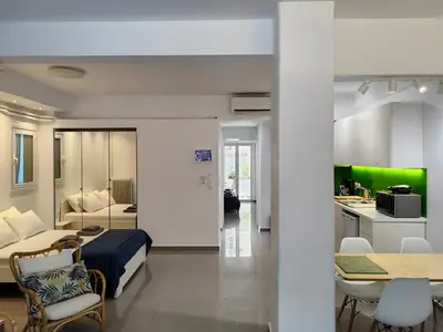 a hotel room with a bed and a kitchen at KYMA Apartments - Athens Acropolis 21 in Athens