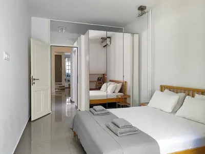 a bedroom with two beds with towels on top of it at KYMA Apartments - Athens Acropolis 21 in Athens