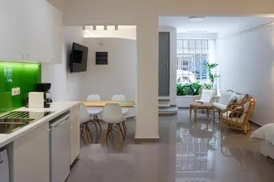 a kitchen and living room with a table and chairs at KYMA Apartments - Athens Acropolis 21 in Athens
