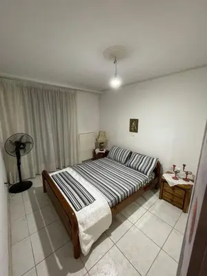 a bedroom with a large bed in a room at Blue Sky on the Sea Appartments in Athens