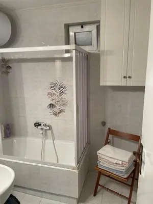a bathroom with a bath tub and a sink at Blue Sky on the Sea Appartments in Athens