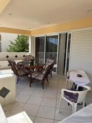 a patio with a table and chairs on a porch at Blue Sky on the Sea Appartments in Athens