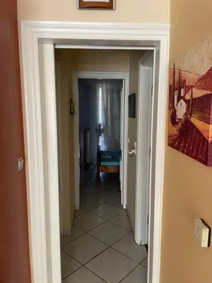 a hallway with a door leading to a room at Blue Sky on the Sea Appartments in Athens