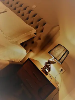 a bedroom with a bed and a table with a lamp at Pallada Athens boutique rooms & apartments in Athens