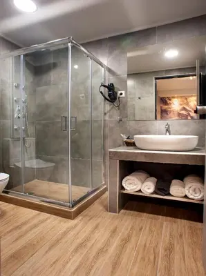 a bathroom with a shower and a sink at Pallada Athens boutique rooms & apartments in Athens
