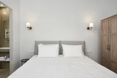 a bedroom with a white bed with two white pillows at Luxury n Chic Athens Museum Apt in Athens