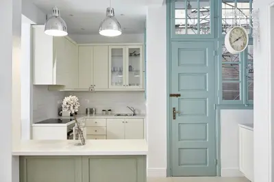 a kitchen with white cabinets and a blue door at Luxury n Chic Athens Museum Apt in Athens