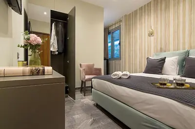 a hotel room with a bed and a bathroom at Athens Imperial Suites - Luxury Living in Athens