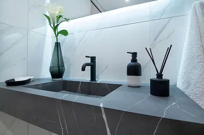 a bathroom with a sink with two vases and a sink at Athens Imperial Suites - Luxury Living in Athens