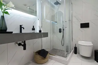 a bathroom with a shower and a sink and a toilet at Athens Imperial Suites - Luxury Living in Athens