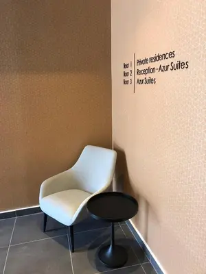a white chair and a table in a room at Azur Suites in Athens