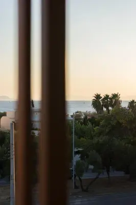 a view of the beach from a window at Azur Suites in Athens