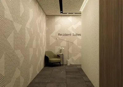 a hallway with a chair and a sign that reads resident suites at Azur Suites in Athens