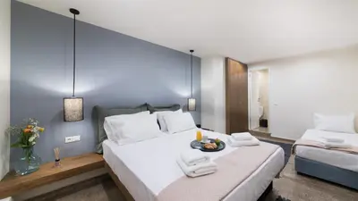 a hotel room with two beds with towels on them at Ciel Living Athens in Athens