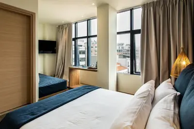 a bedroom with a bed and a large window at Ciel Living Athens in Athens