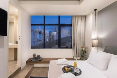 a bedroom with a bed and a large window at Ciel Living Athens in Athens