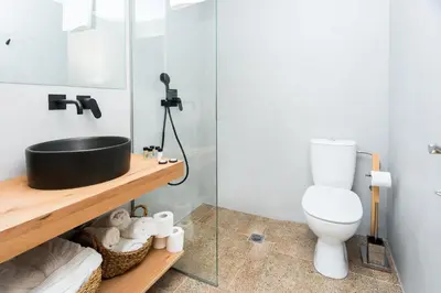 a bathroom with a sink and a toilet at Ciel Living Athens in Athens