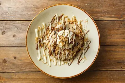 a plate with a dessert on a wooden table at Ciel Living Athens in Athens