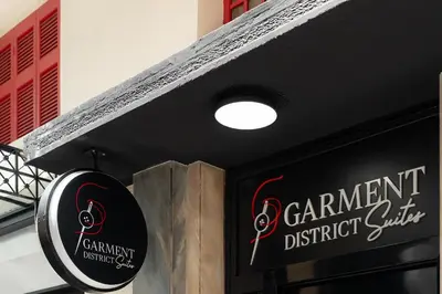 a sign for a restaurant with a sign for a restaurant district center at Garment District Suites in Athens