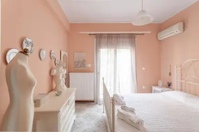 a bedroom with a white bed and a window at Maria's Home in Dhaskalión