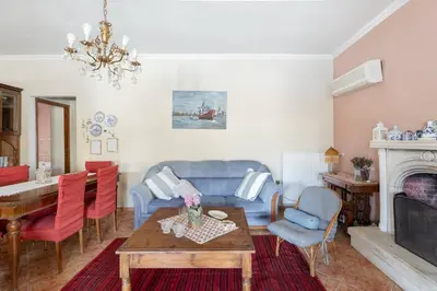 a living room with a blue couch and a table at Maria's Home in Dhaskalión