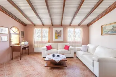 a living room with white couches and a table at Maria's Home in Dhaskalión