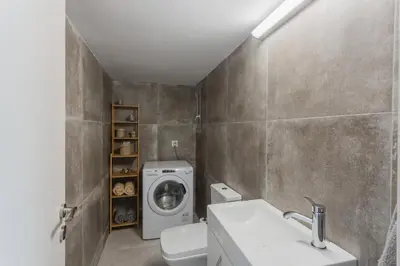 a bathroom with a washing machine and a washer and dryer at 100m2 Luxury Apartment in the Heart of Athens - Living Stone Emerald in Athens